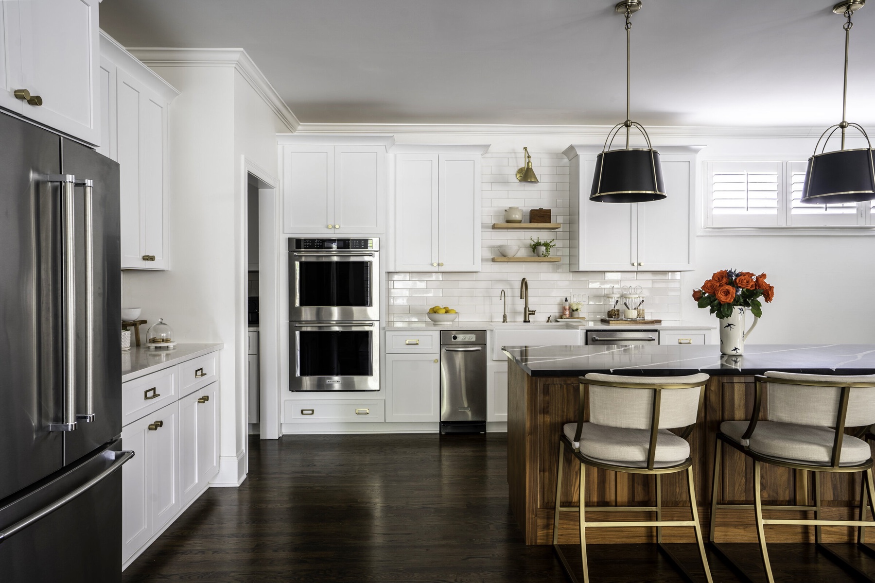 Kitchen by Holly Thompson Design in white, walnut, and brass