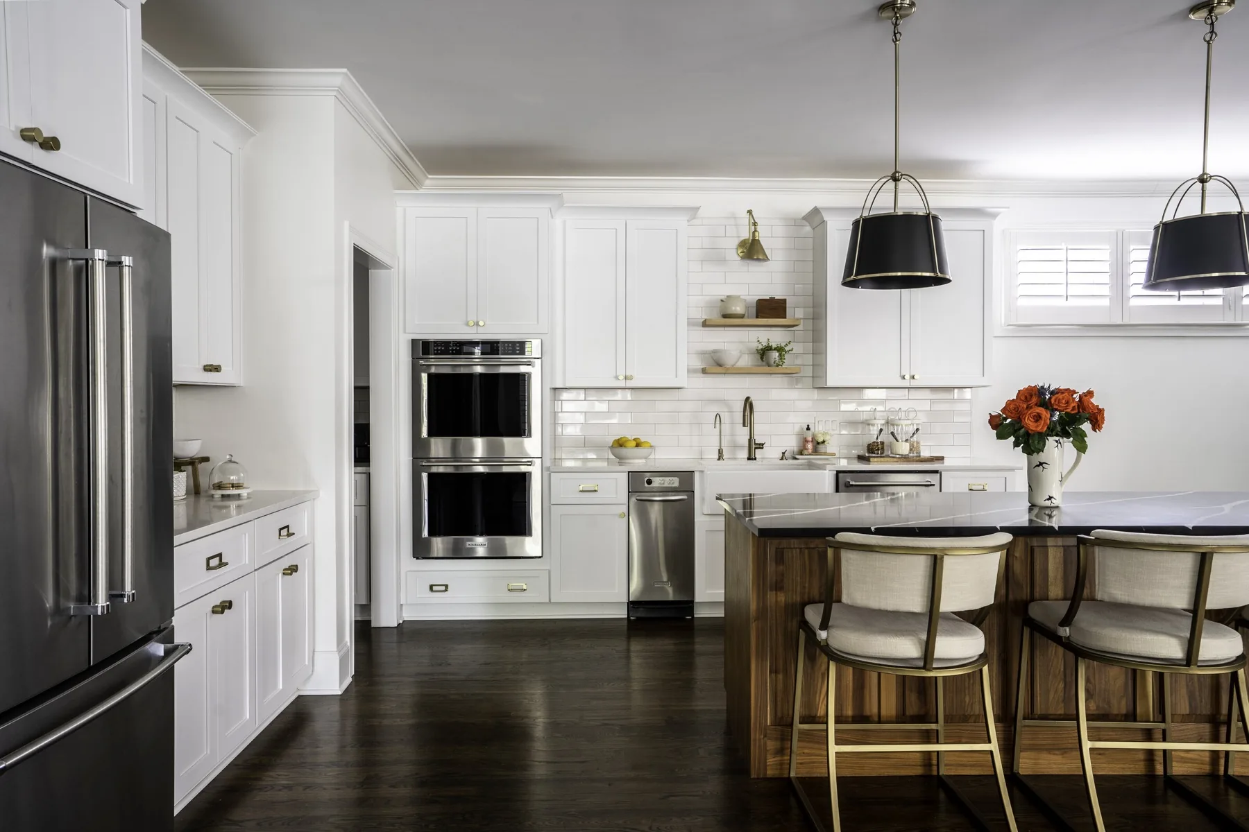 Kitchen by Holly Thompson Design in white, walnut, and brass