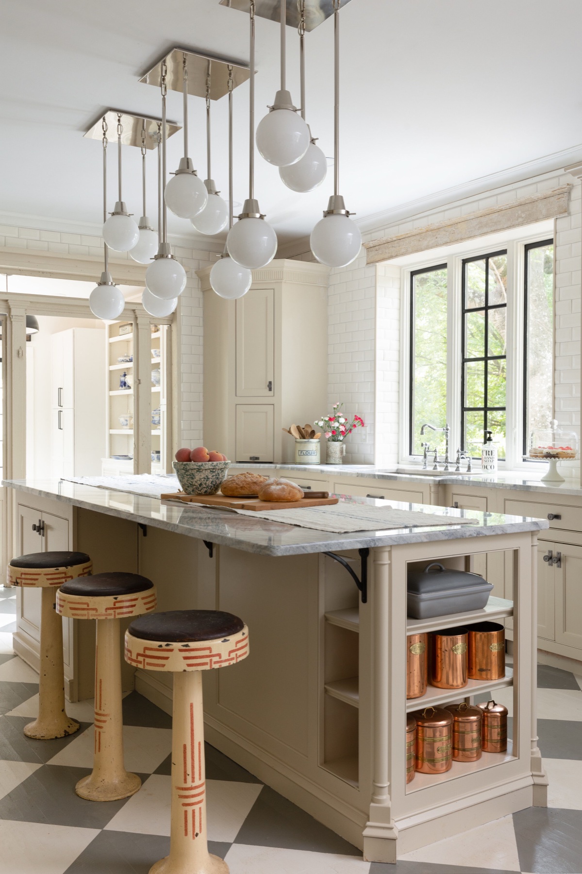 Cream kitchen with checkerboard floor and copper canisters