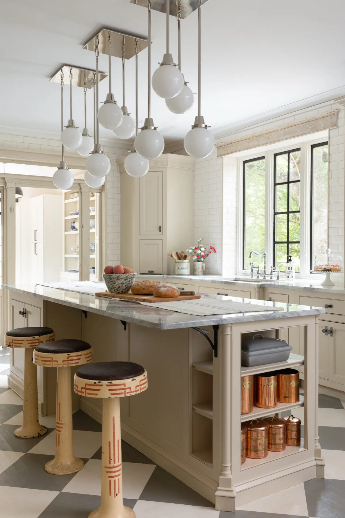 Cream kitchen with checkerboard floor and copper canisters